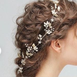 Wedding headpiece with crystals, pearls, and gold embellishments.